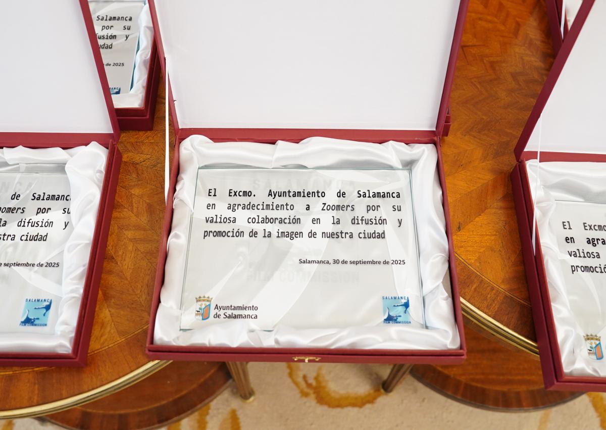 Imagen secundaria 1 - Menéndez de Zubillaga recogiendo el obsequio del Ayuntamiento, detalle de los obsequios y el alcalde con el equipo en el balcón de la Plaza Mayor.
